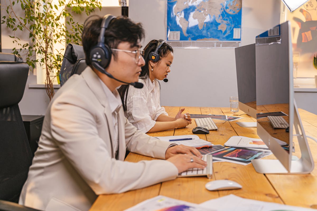 Customer service team members working with headsets in an operations office