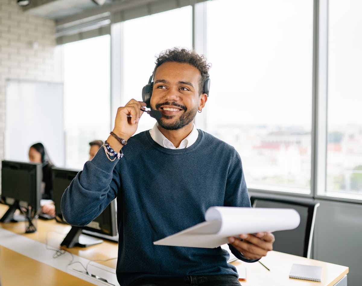 Operations team member wearing a headset while reviewing paperwork
